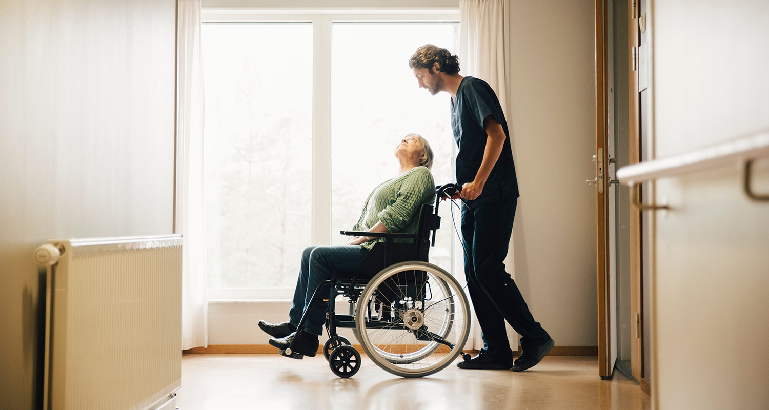 provider pushing woman in wheelchair